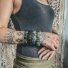 Carnelian, Jade, Labradorite & Obsidian bracelets worn on a female hand with tribal tattoos