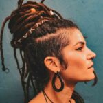 wooden tear drop earrings worn by a girl with a top knot of dreadlocks - CrafterElena