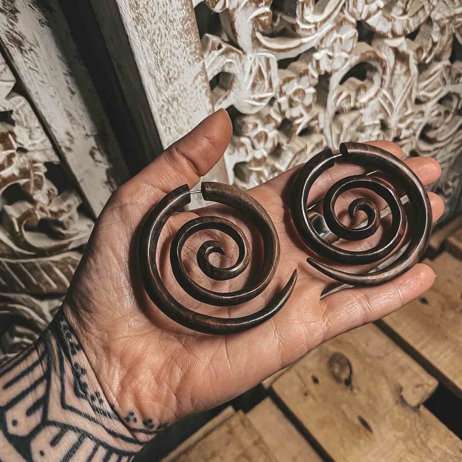 wooden spiral earrings fake gauge large size in a hand