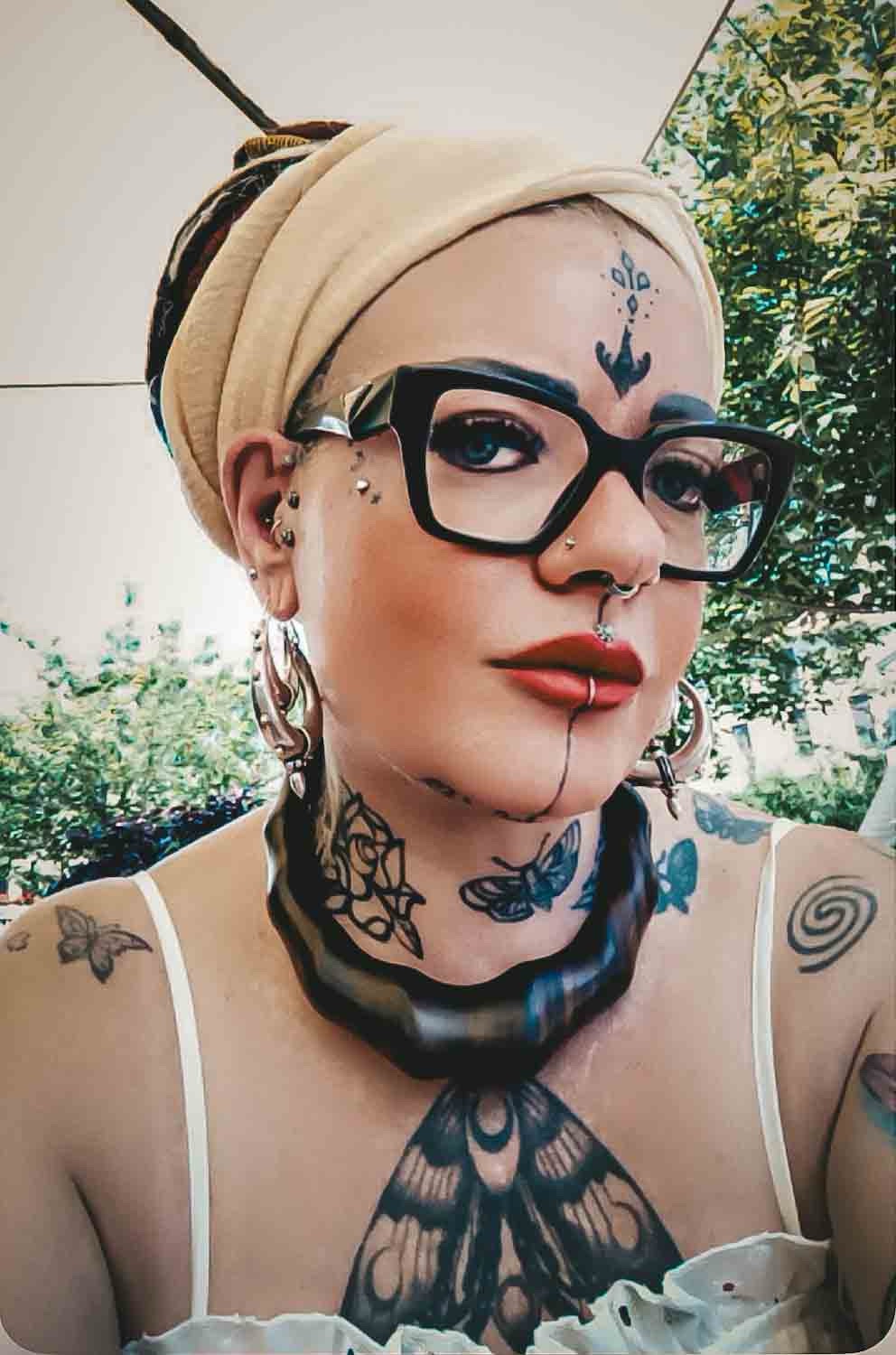 komisa choker komisa choker and large beige scarf and silver medi earrings on girl with tattoos