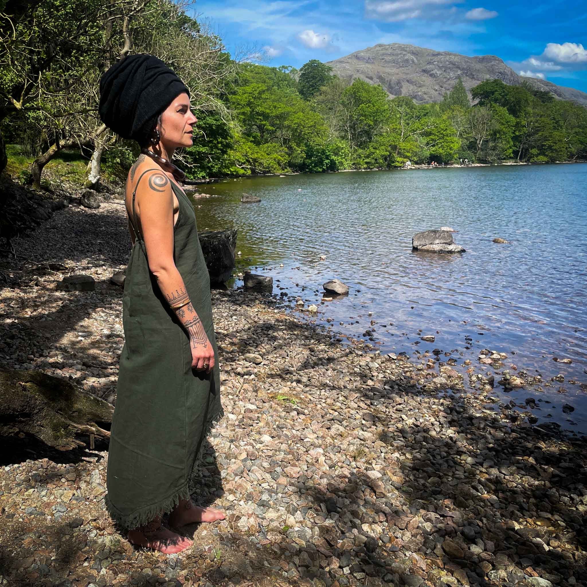 Fringe Boho Linen Dress Green model next to a lake showing the side of the dress