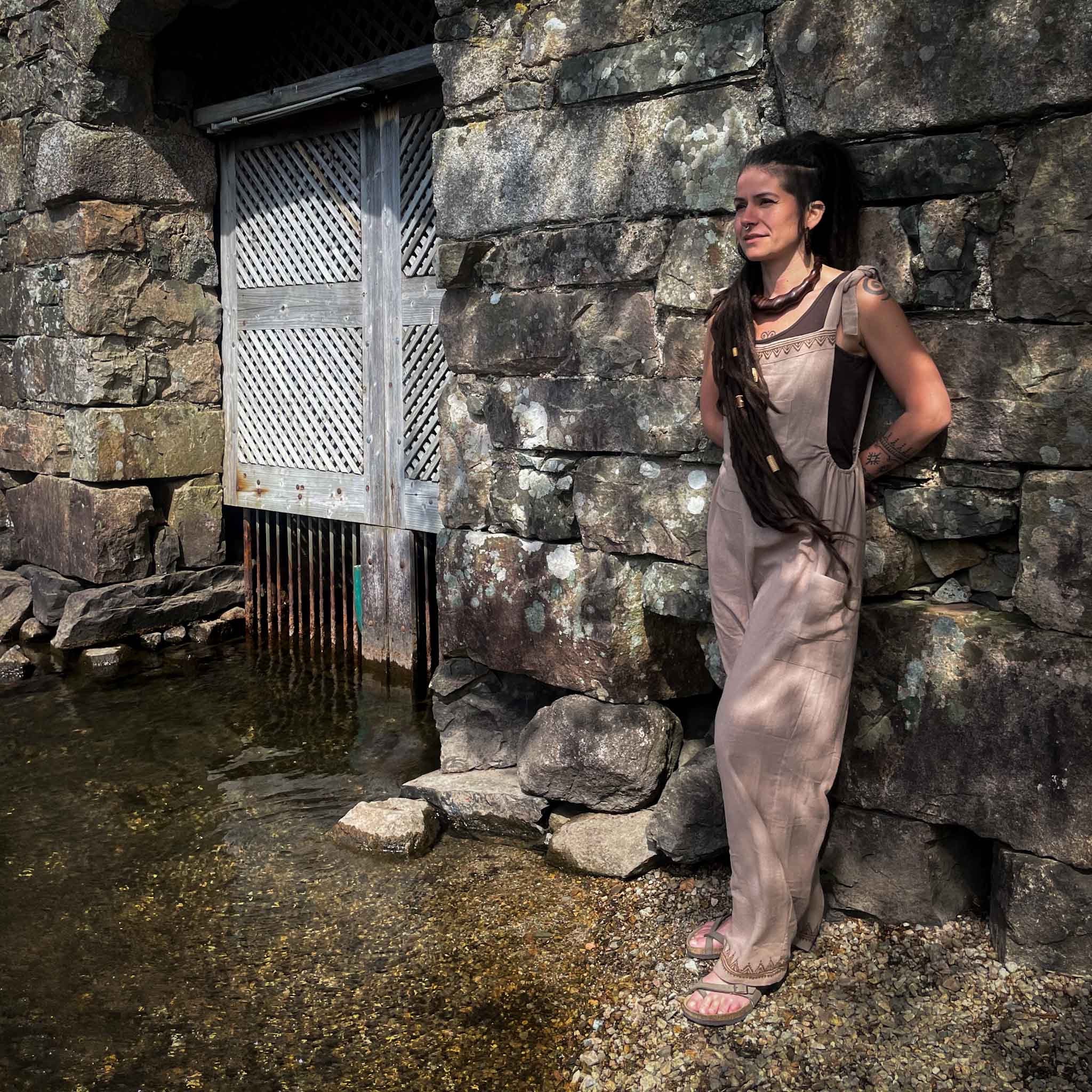 Jumpsuit Hippie Dungarees Blockprint Tribal Pattern Beige Linen 100% Cotton Natural Dye CrafterElena next to a boat house