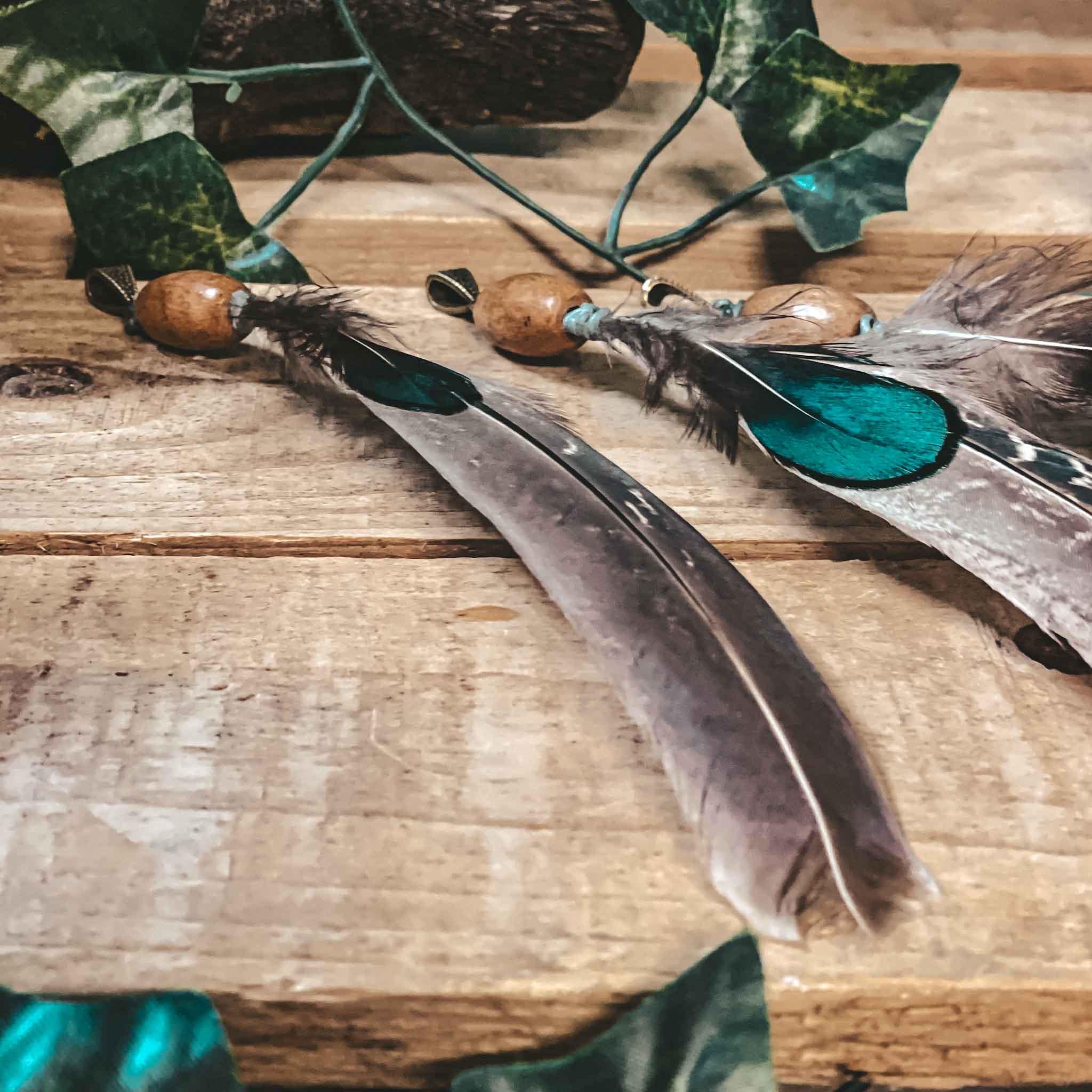 Pheasant feather dreadlock bead hair decoration pheasant feather dreadlock bead hair decoration. Made from natural pheasant feathers, a handmade wooden bead, and finished with antique bronze accent bead,