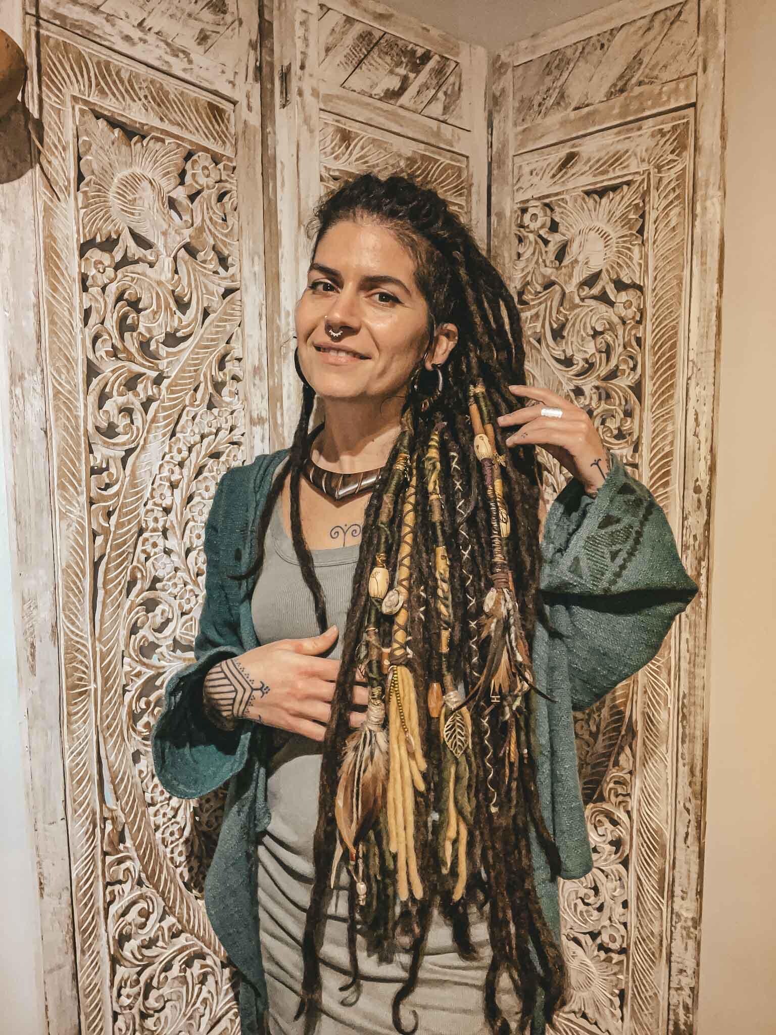 Nature’s Spirit Hair wrap by crafterelena Nature's spirit dreadlock hair wrap natural earthy style autumnal festival hair accessories in greens yellow orange, brown purple with pyrography beads burned with botanical theme,wooden pendants, feathers, mushrooms, sun and moon pendants on dreadlock girl crafterelena