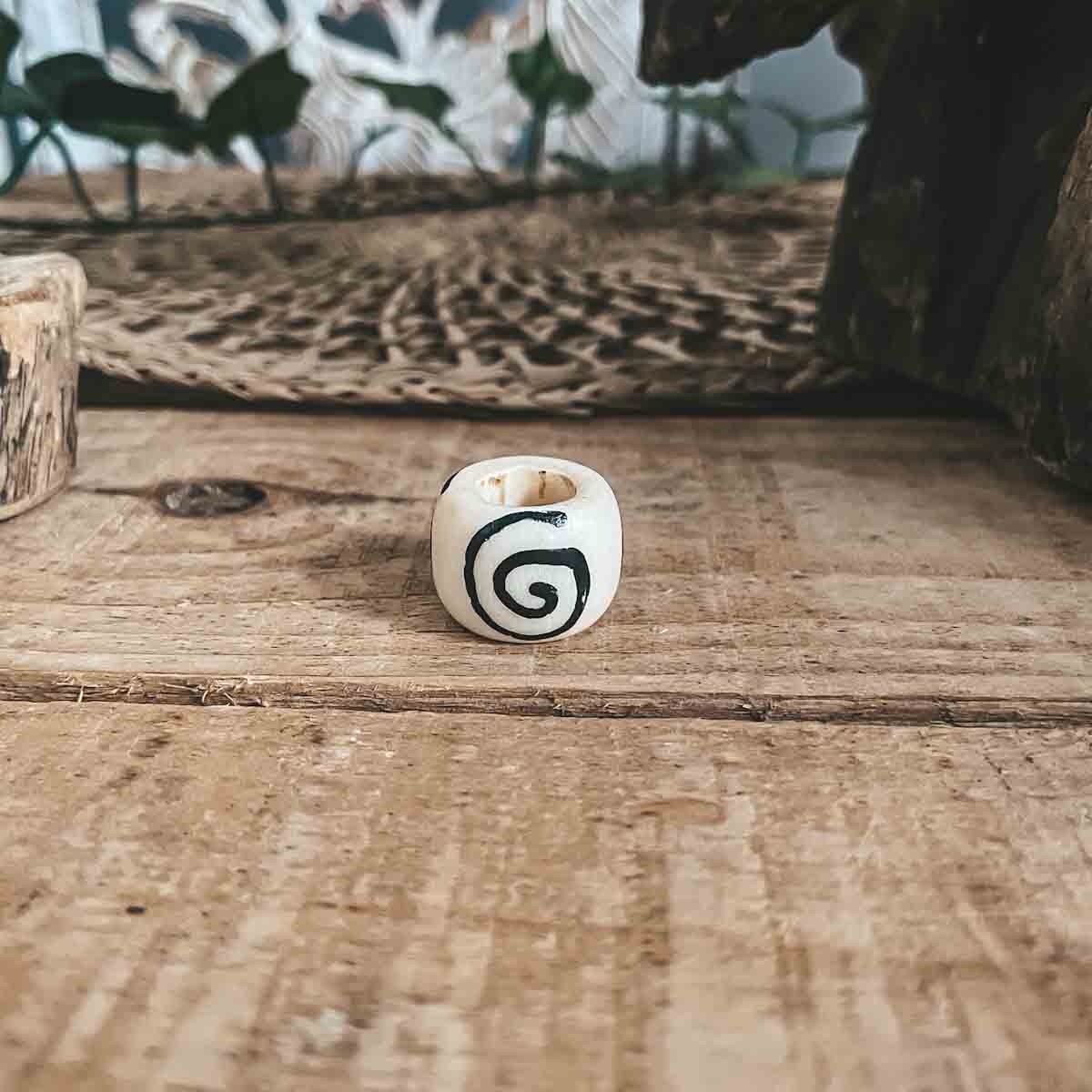 White camel bone bead with spiral pattern