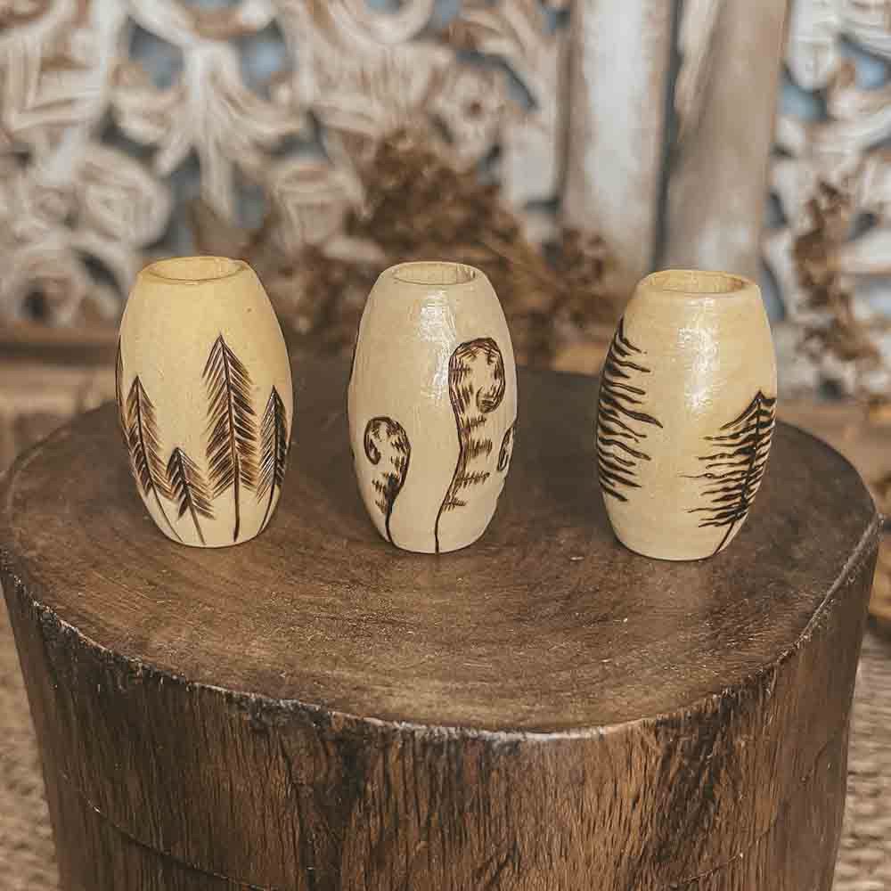 deep forest hand burned design with pyrography technique on 3 large wooden dreadlock beads on an angle